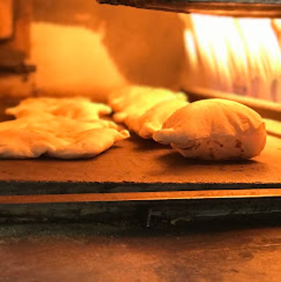 Rows of samoon puffing up inside the oven